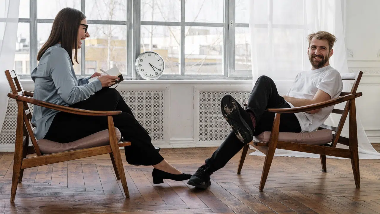 Man and Woman Sitting Down and Laughing