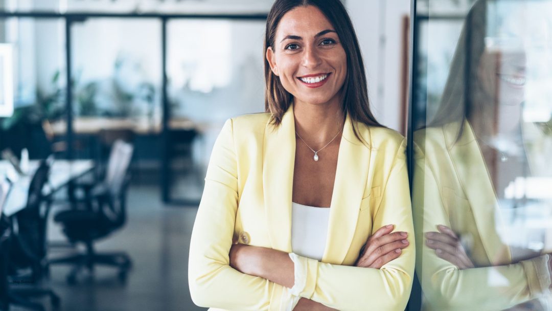 a woman smiling at camera in an office setting